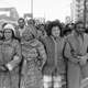 Dick Gregory, third from right, arm in arm with the family of Dr. Martin Luther King, Jr in 1985. Image via the AP.
